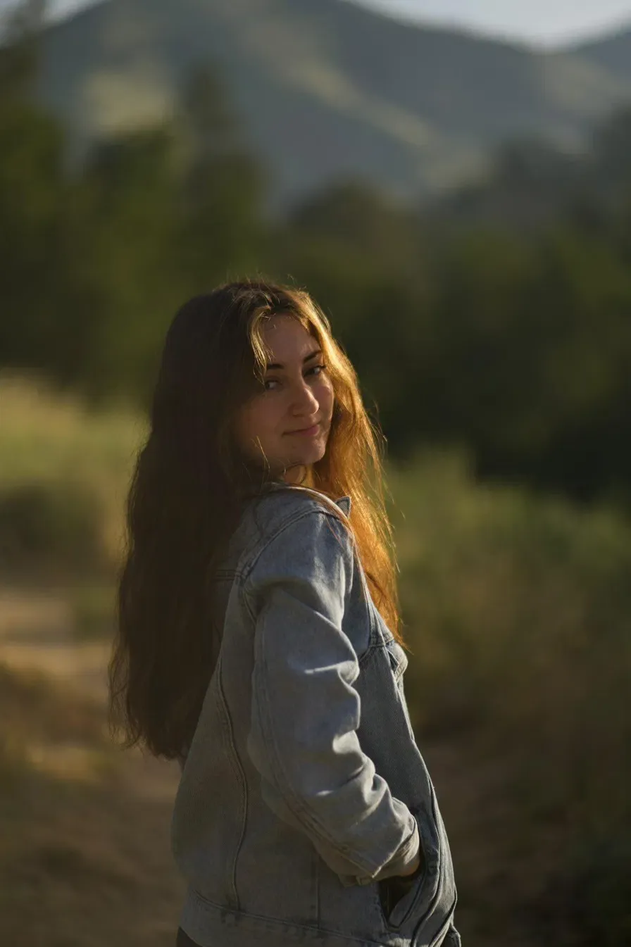 Kaylee, the filmmaker behind KayMo Film Co, at golden hour